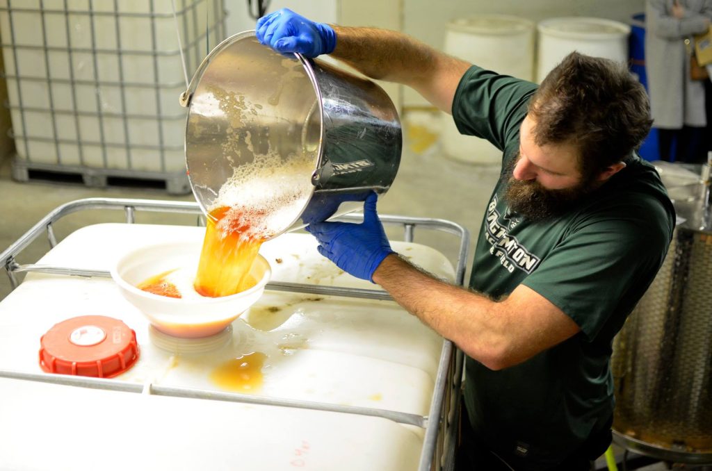 cidermaker pouring cider